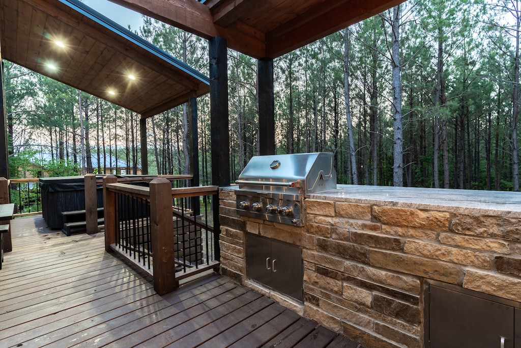 Outdoor deck with a built-in stainless steel grill.