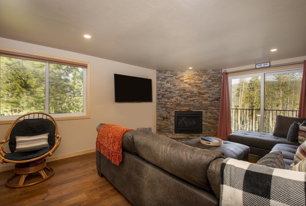 Cozy up by your stone fireplace while forest views surround this bright, modern retreat.