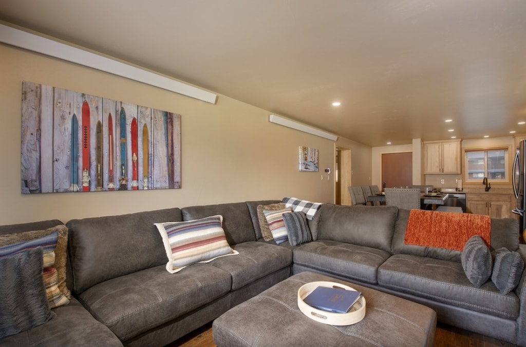 Sink into plush sectional seating where your group can unwind together, with colorful ski artwork creating perfect mountain vibes.