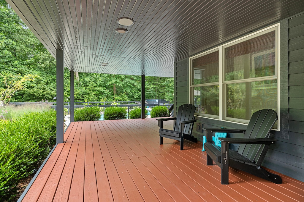 Picturesque wooden porch with serene garden surroundings.