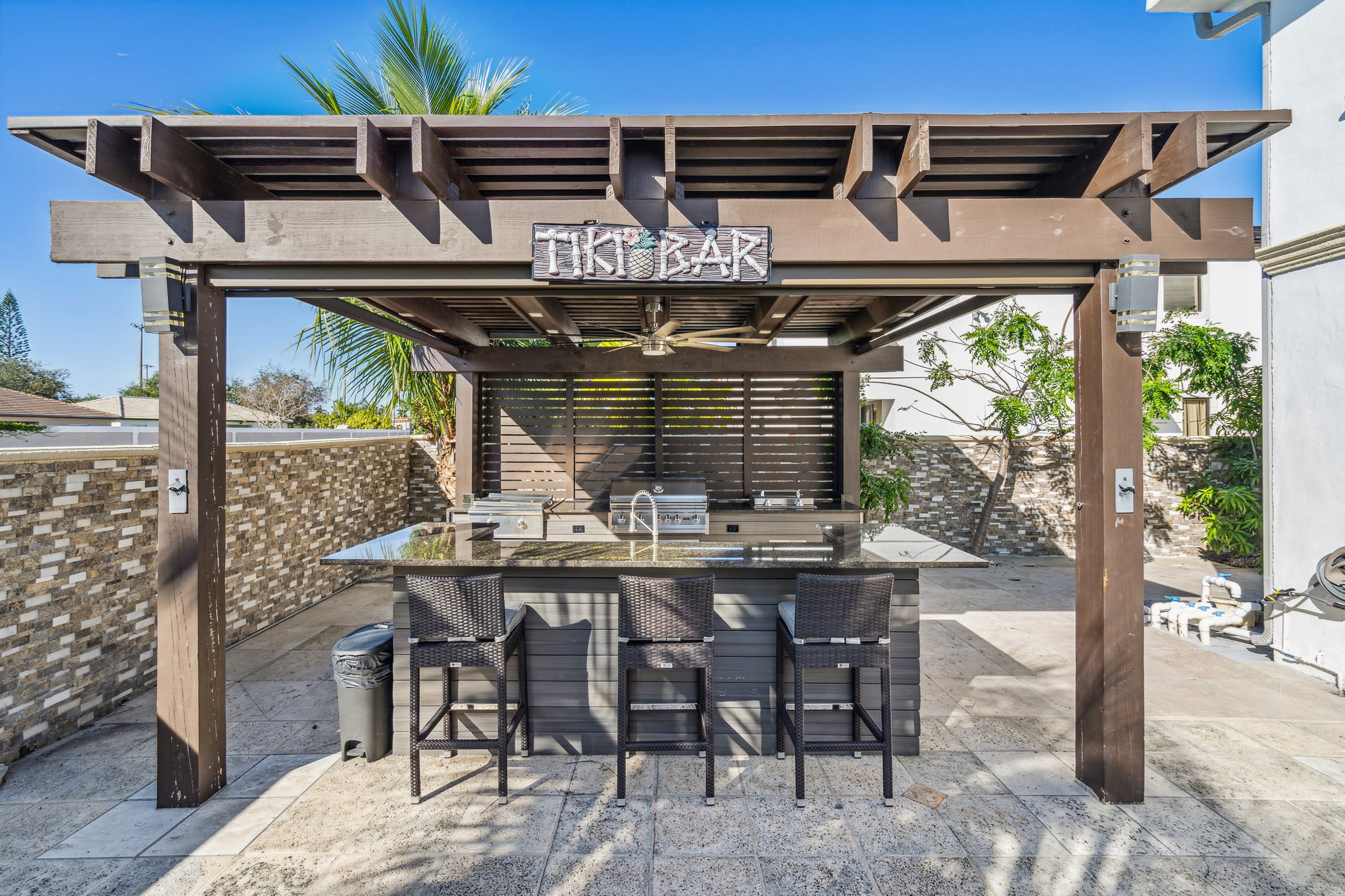 Who’s ready to take outdoor living to the next level?! This outdoor kitchen features a BBQ grill, a wet bar, and bar stool seating so you can serve the food piping hot and the drinks nice and cold!