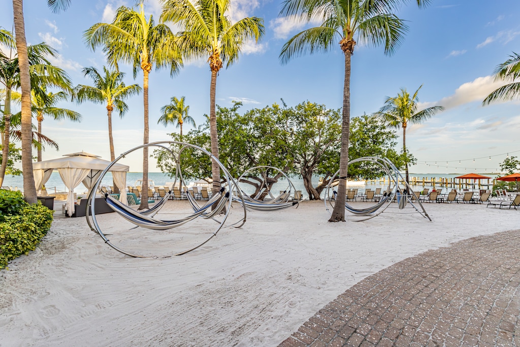 Unwind under swaying palms in unique circular hammocks right on the sand.