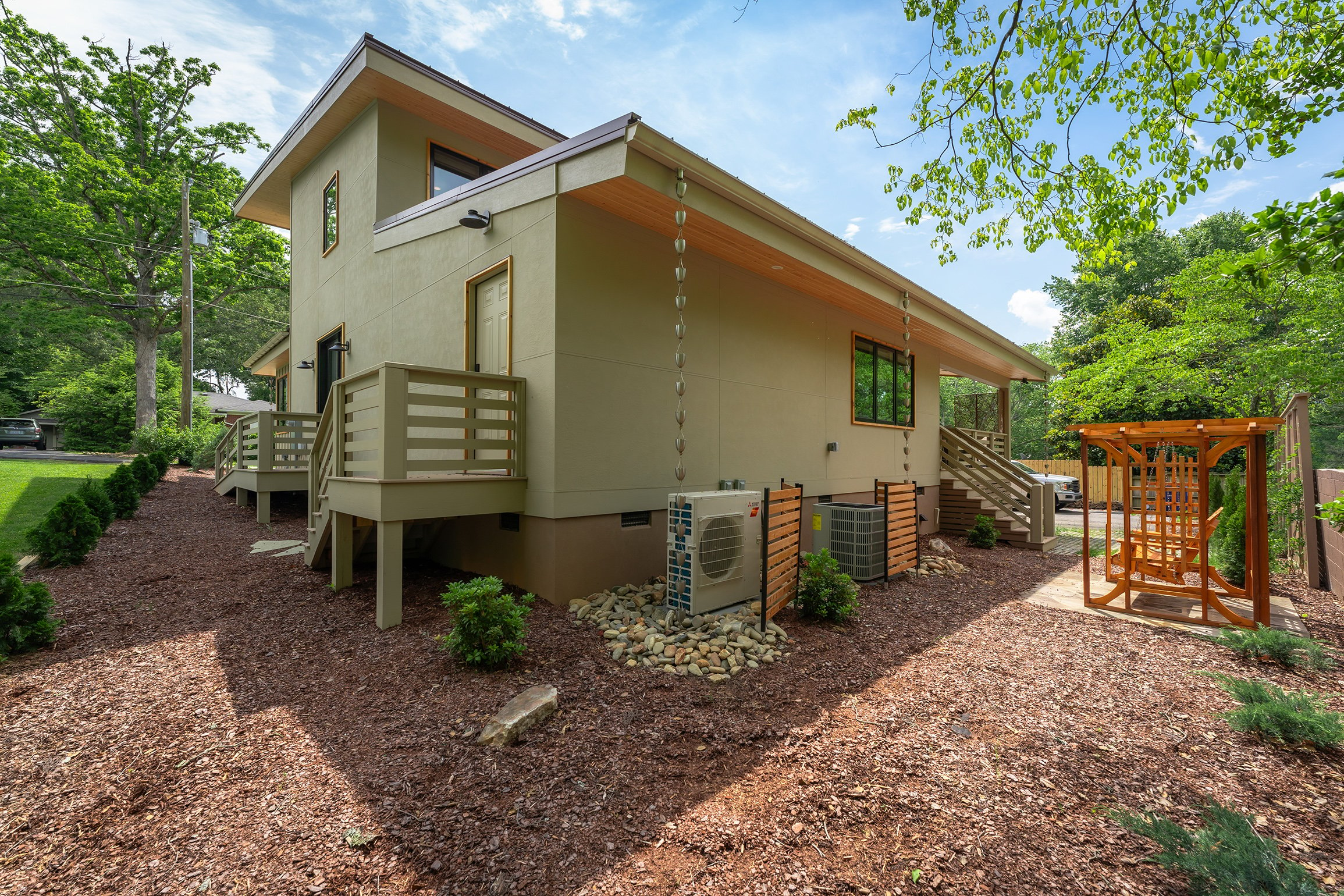 Step down from the covered back deck to the backyard and a wooden swing