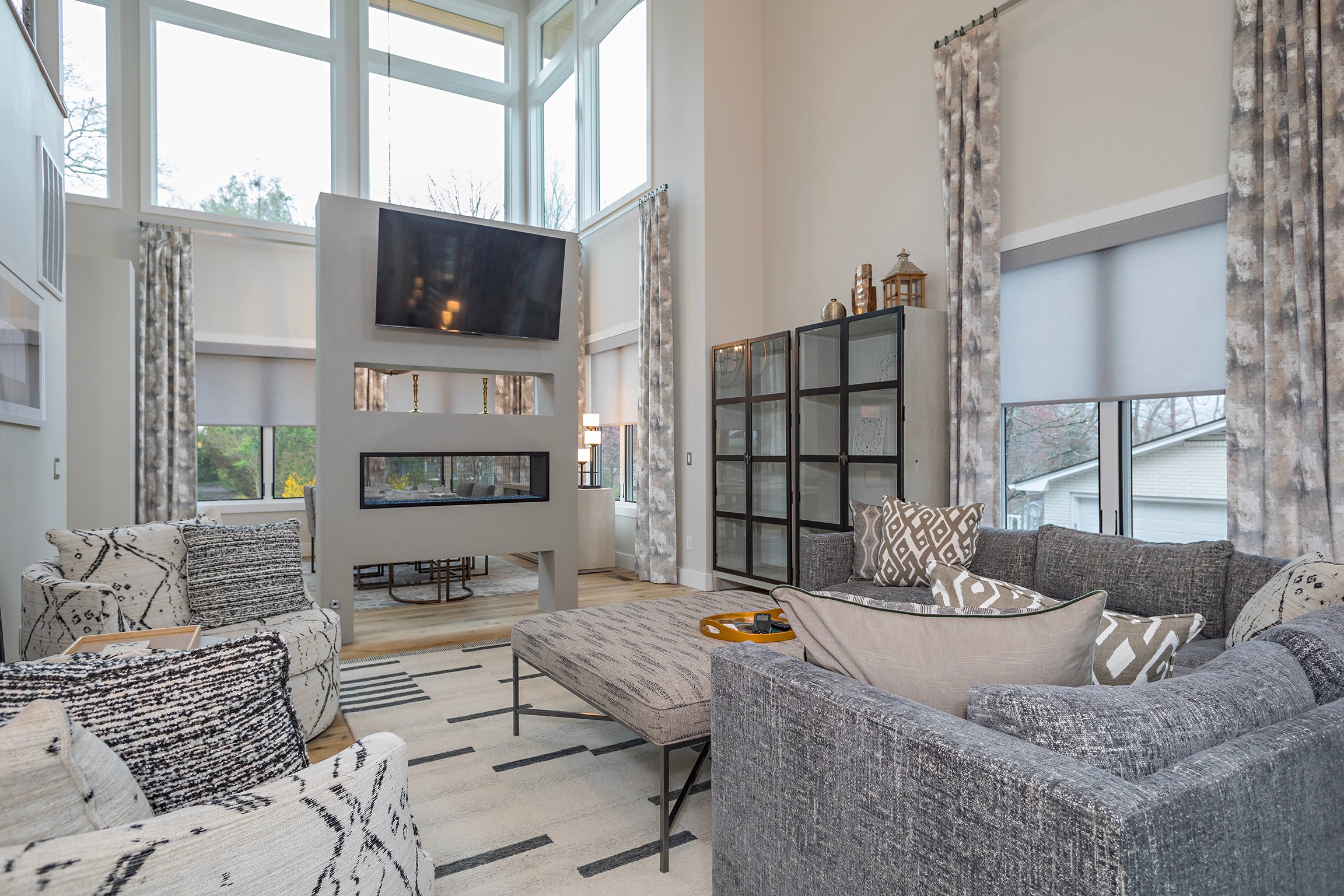 Living room with double-sided gas fireplace and TV for streaming