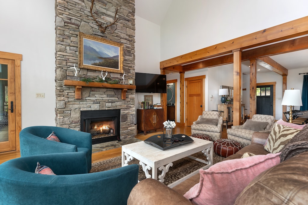 Impressive great room with floor-to-ceiling windows, gas log fireplace, and TV for streaming