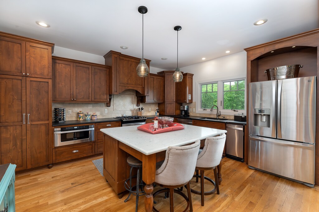 Well-equipped kitchen with gas range, standard drip coffee pot, Keurig, and coffee grinder