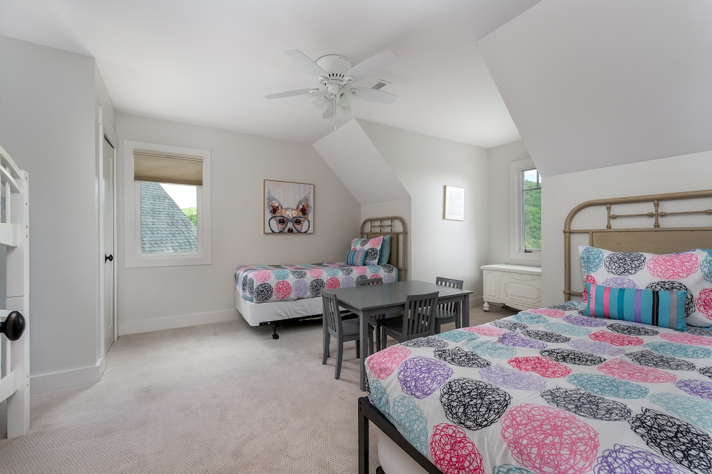 Upper level bedroom with two twin-size beds and one bunk bed