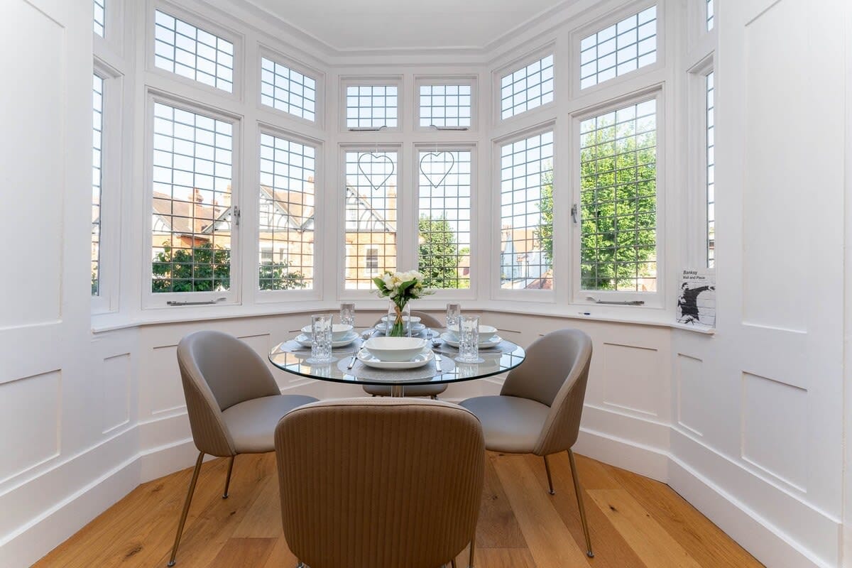 Dine together in the beautiful bay window complimented by wooden floors and panelled walls. 