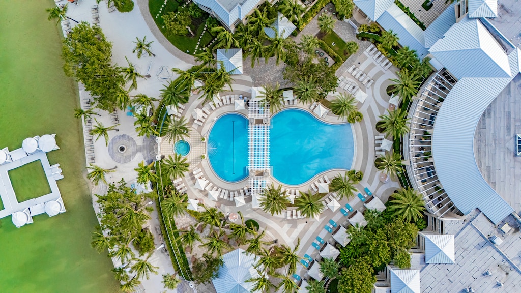 Resort pool with cabanas & palm trees 🌞 — available for all guests (not a private pool).