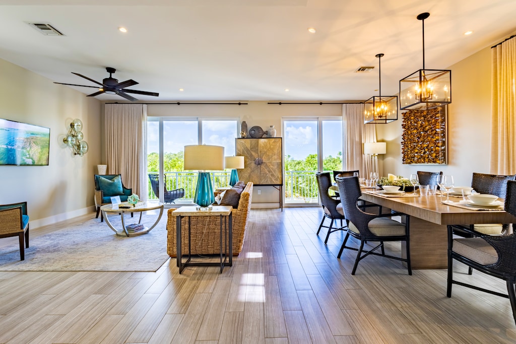 Stylish living and dining space with natural light and balcony views.