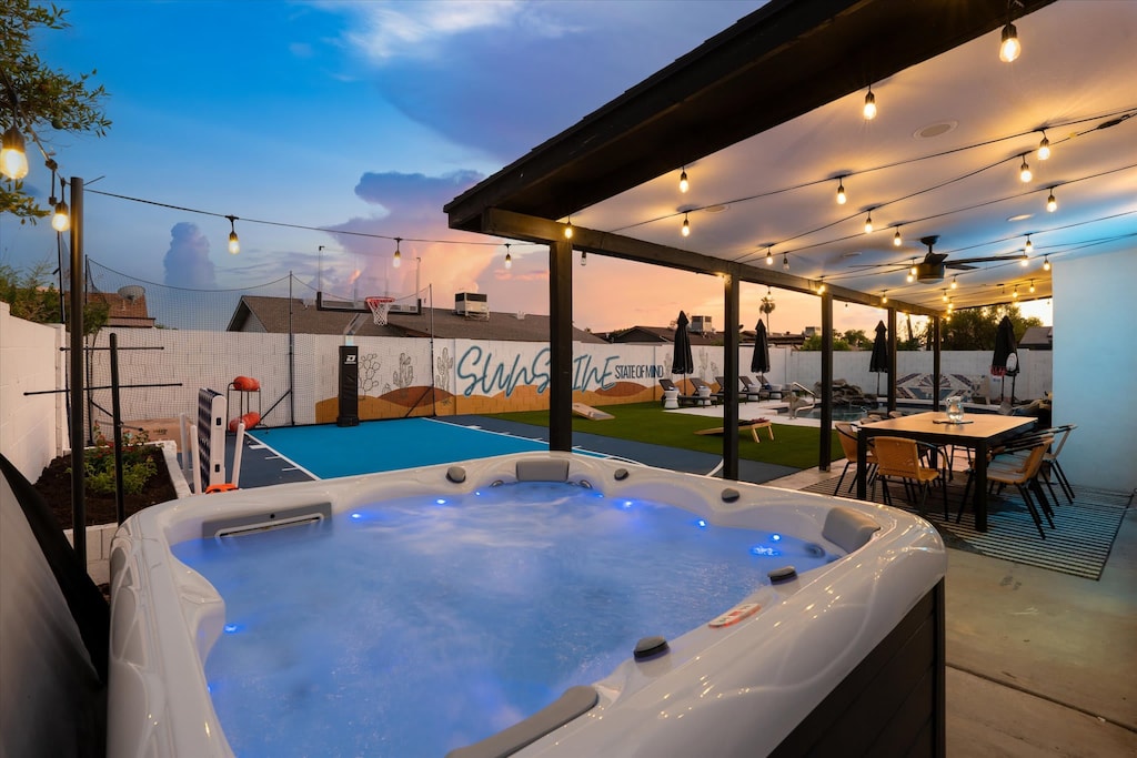 Unwind in our backyard hot tub while watching the stunning sunset