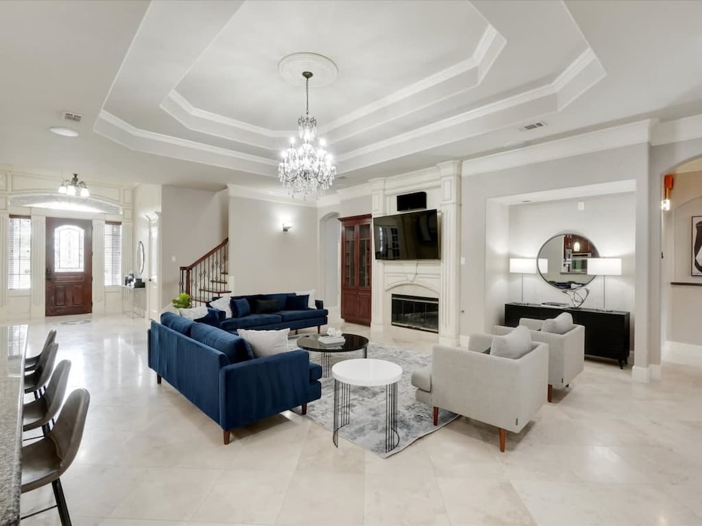 Nothing says luxury like a chandelier! With an elegant air of “posh meets modern”, this living room caters to easy conversation and good times.