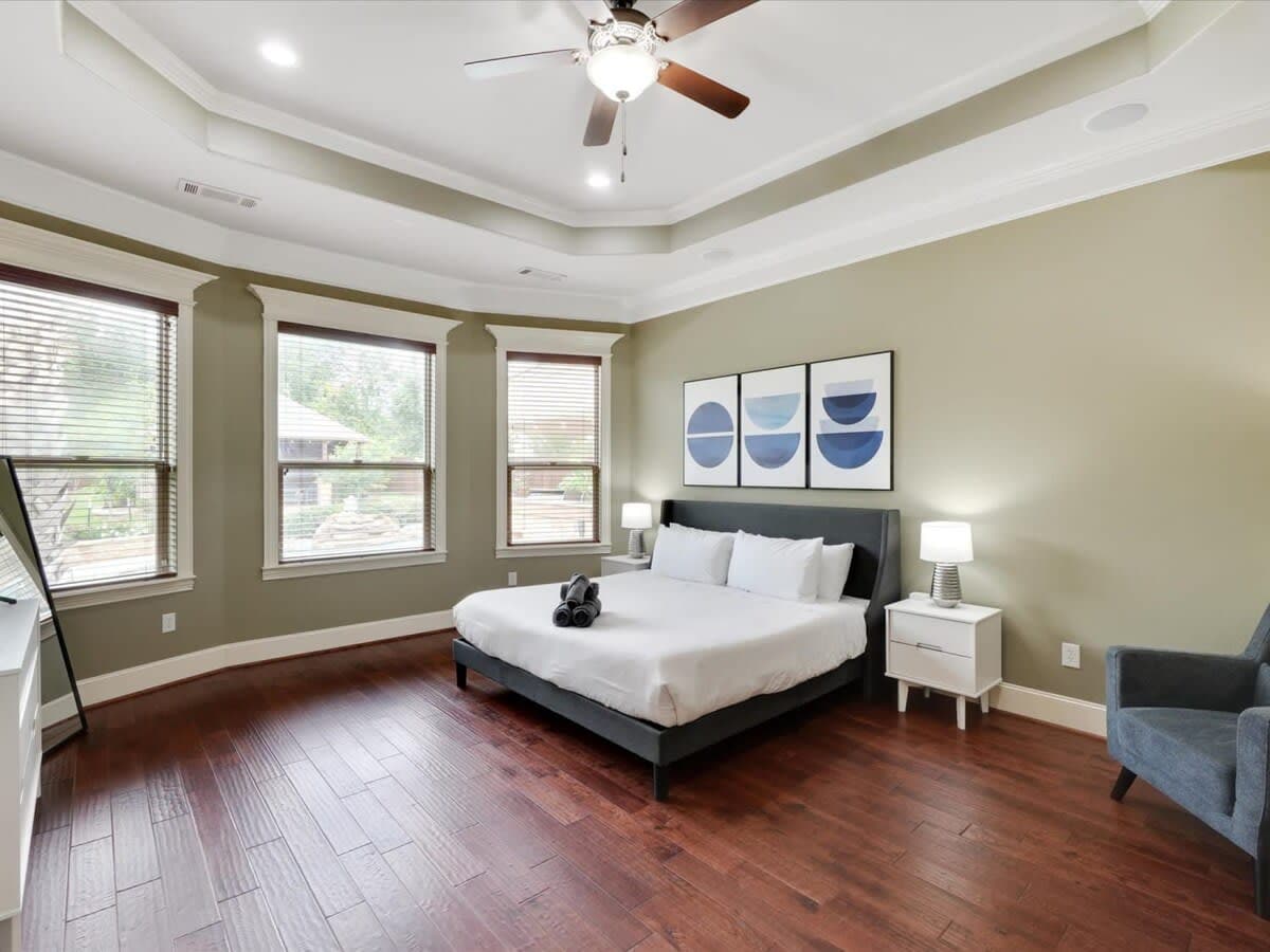 Let the gentle morning rays from the bay windows coax you awake in this primary bedroom, furnished with a king-sized bed so you have plenty of space to stretch out!