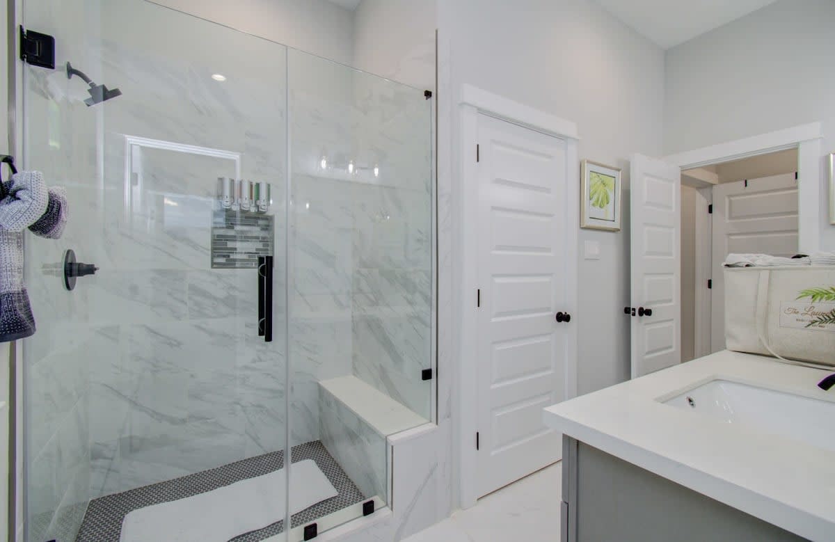 Check out this exquisite glass walk-in steam shower! It’s like your very own personal space and even includes a sitting area!