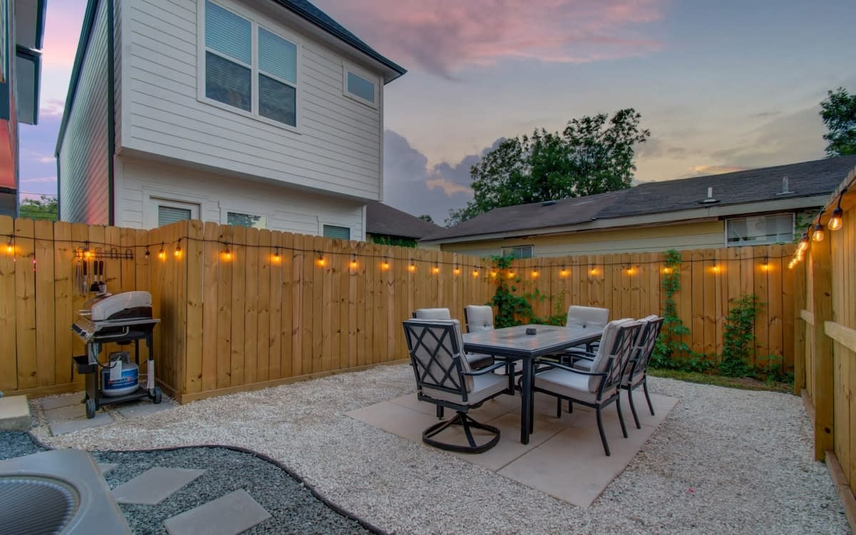 Enjoy a nice outdoor meal from the comforts of your very own backyard patio! There are even string lights for the perfect evening ambiance.