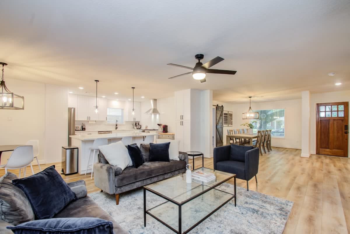 This living room has been furnished with comfortable couches, a modern coffee table, and aesthetic touches to create a comfortable environment for all