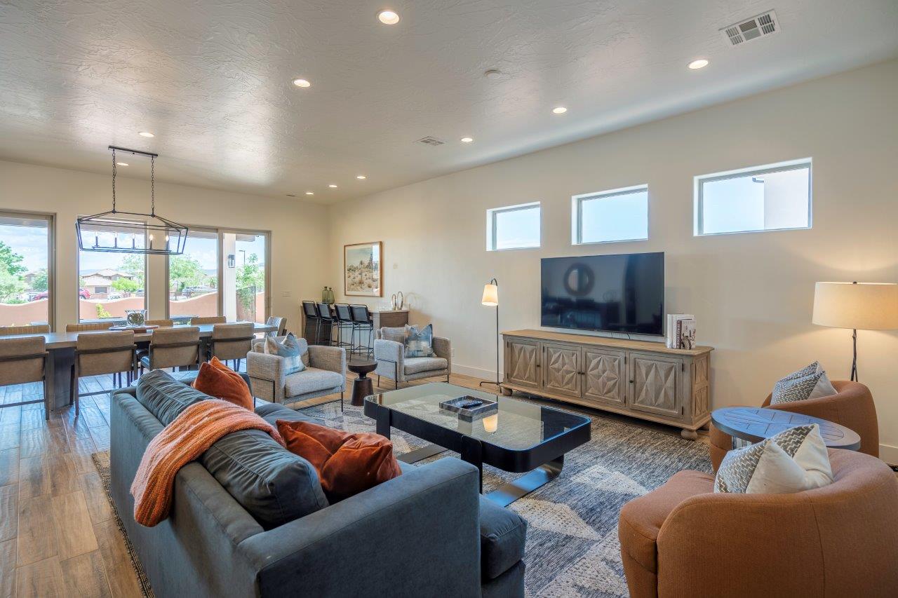 Spacious living room with sofa seating and TV