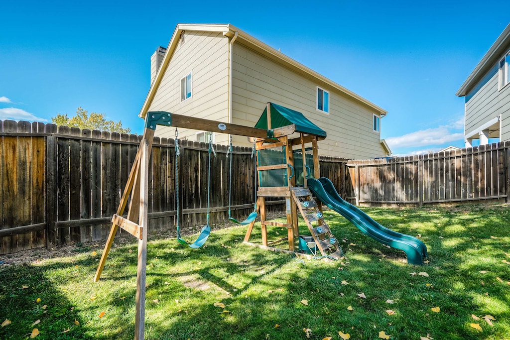 Family fun awaits in the backyard with this playground set—perfect for kids to enjoy while you relax on the patio!
