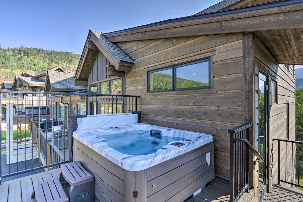 Private hot tub on balcony with beautiful mountain views.