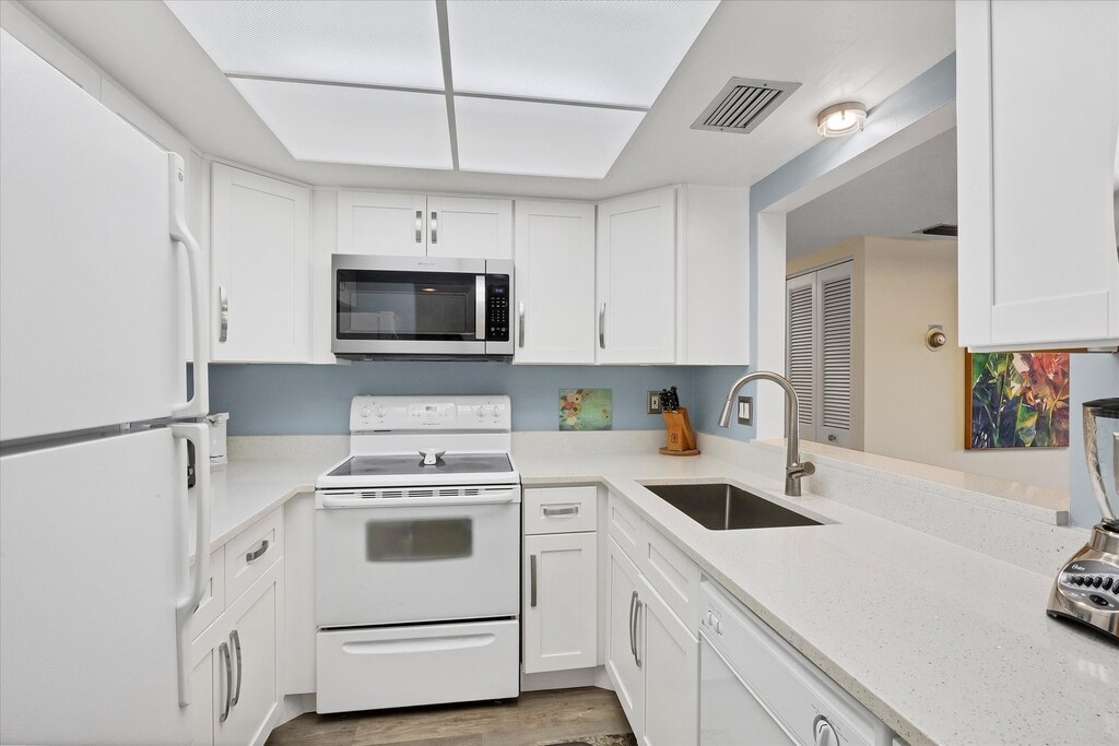 Bright, fully-equipped kitchen overlooking dining room / living room