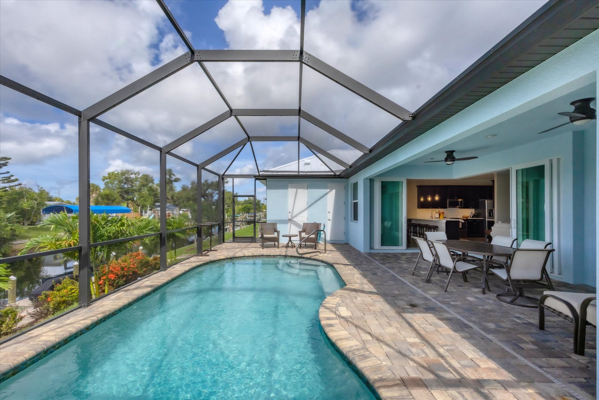 Gorgeous, large lanai with sparkling pool overlooking the canal. Lanai also features a dining table for 6 and 32-inch Smart TV. Pool size: 22' x 8' x 6'D