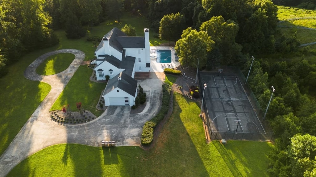 Drone images showing some of the exterior amenities  including the pool, hot tub and sports courts. some guests have family tournaments of pickleball