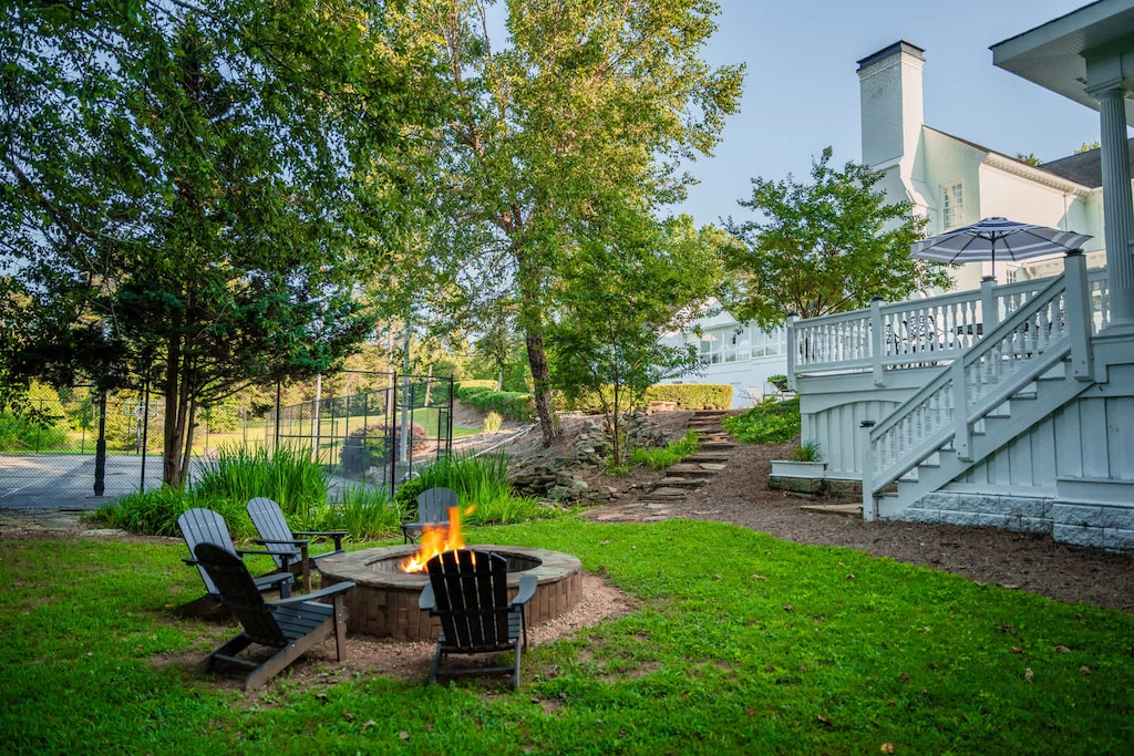 firepit area out back with Adirondack chairs
