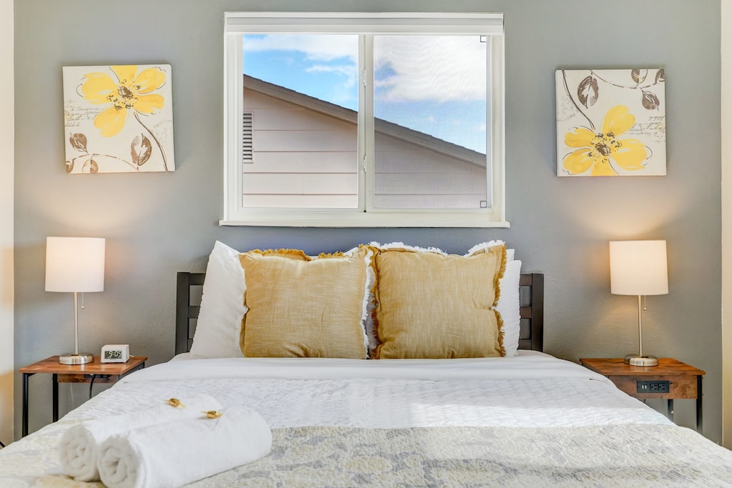 Relax and unwind in this cozy, light-filled bedroom at Quarry Peak, featuring a comfortable queen bed with soft pillows, stylish decor, and a calming ambiance perfect for restful nights.