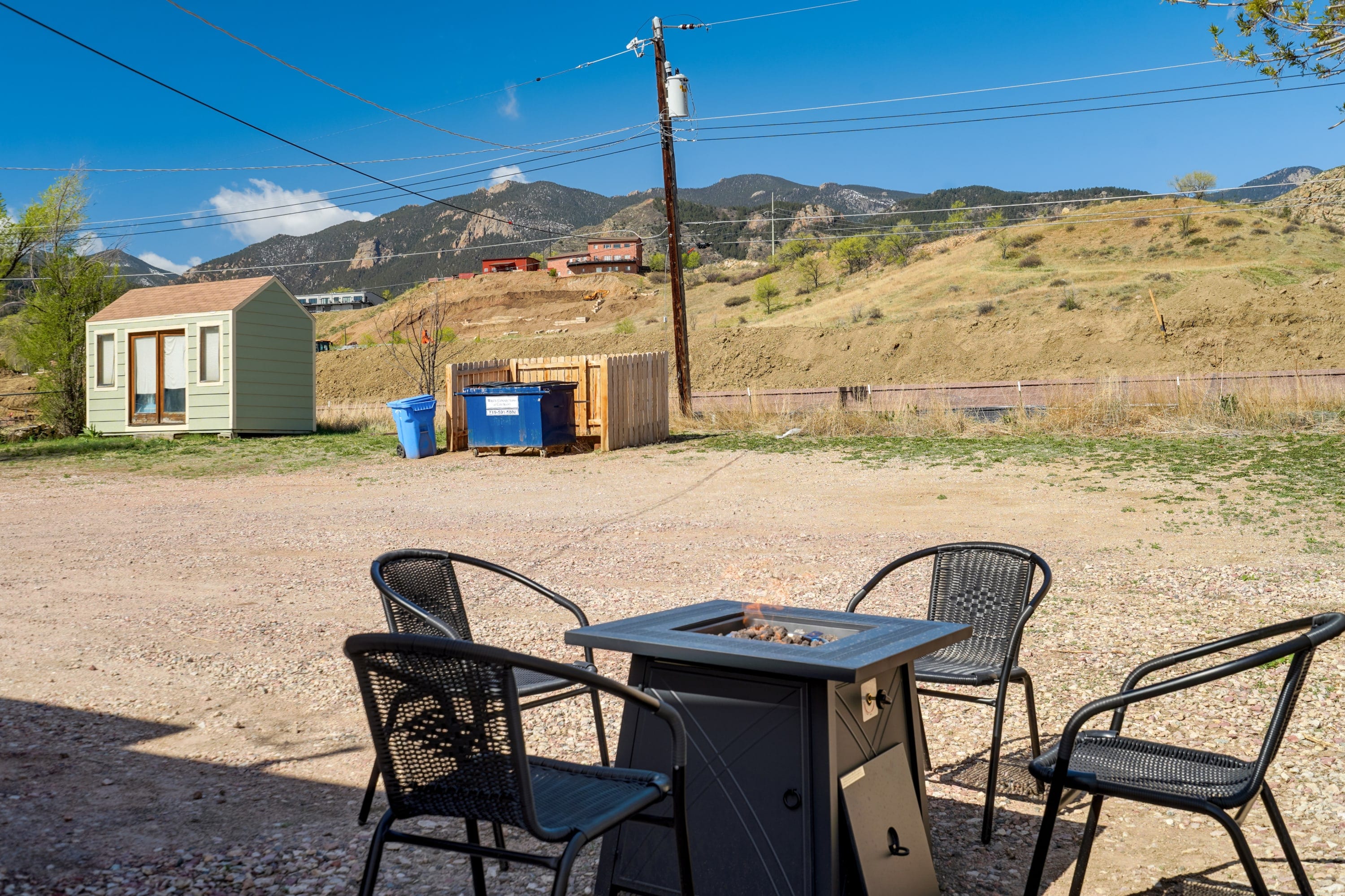 Fire pit with a table and chairs for gatherings.