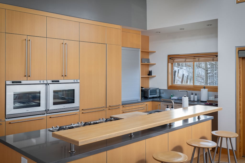 Kitchen - Fully equipped with built-in appliances and breakfast bar seating for 4