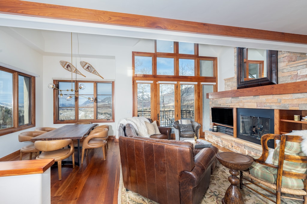Living Room - Modern space with floor-to-ceiling windows, comfortable seating and fireplace