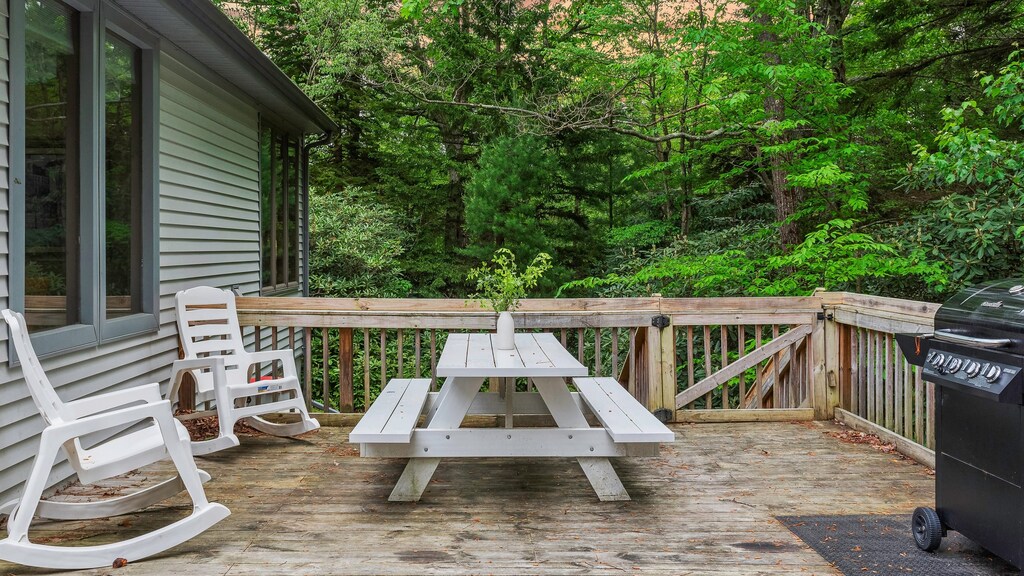 This wooden deck with a grill is the perfect place to relax and enjoy the outdoors.
