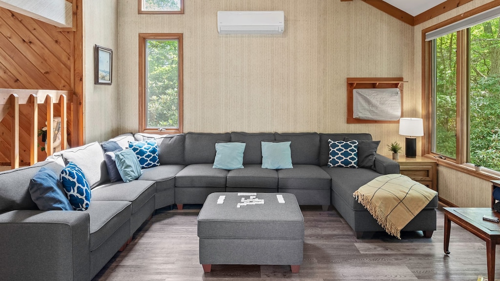 A living room with a comfy couch, and fireplace.