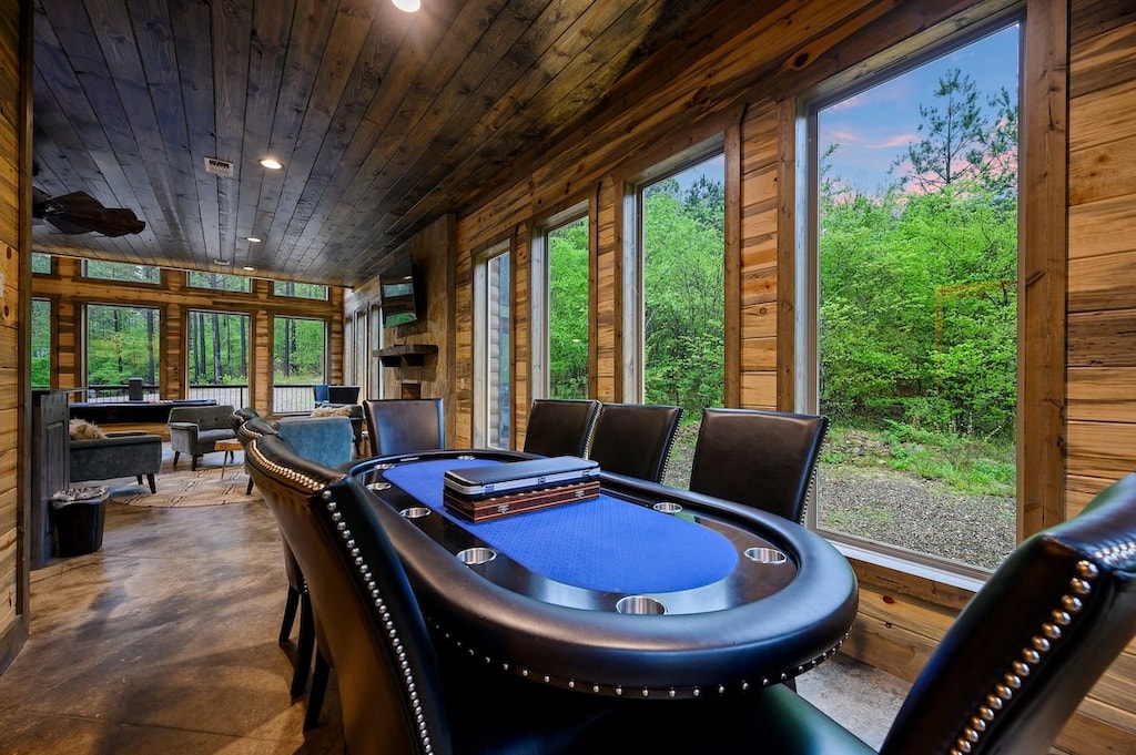 Spacious game room with pool, shuffleboard, arcade, and card table