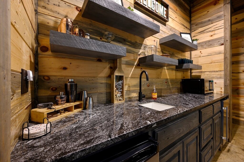 Game room wet bar with beverage refrigerator and ice maker