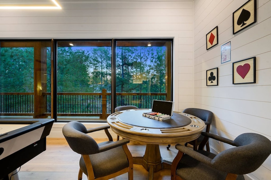 Game room with arcade, card table, darts, and air hockey