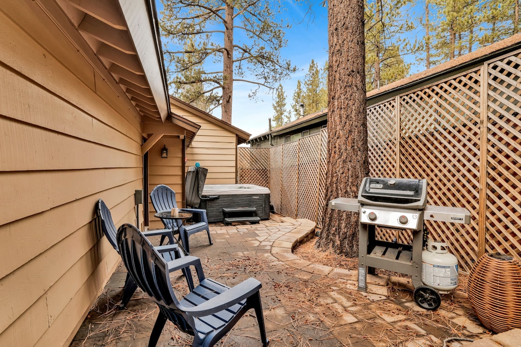 Private outdoor hot tub, surrounded by tall pines, perfect for relaxing under the trees after a day of adventure—enjoy peaceful forest views, fresh air, and a truly rejuvenating stay.