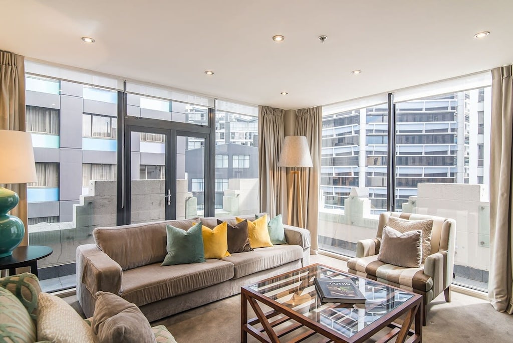 Living area with designer furnishings and floor to ceiling windows