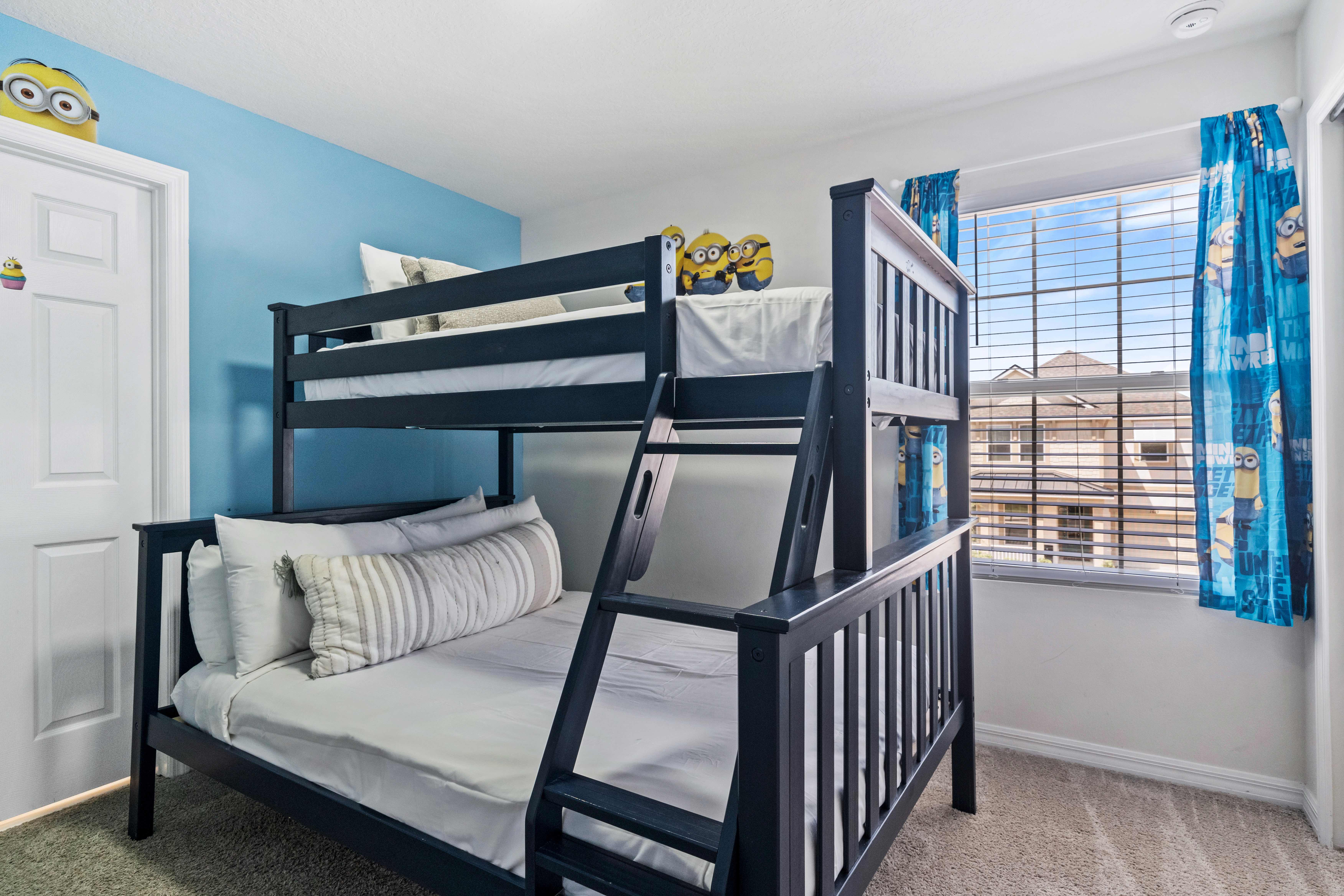 Immerse yourself in the world of Minions with our themed bedroom of the home in Kissimmee - Featuring a double and single bunk bed adorned with playful decorations. - Perfect room for sibling bonding with elegantly carpeted floor