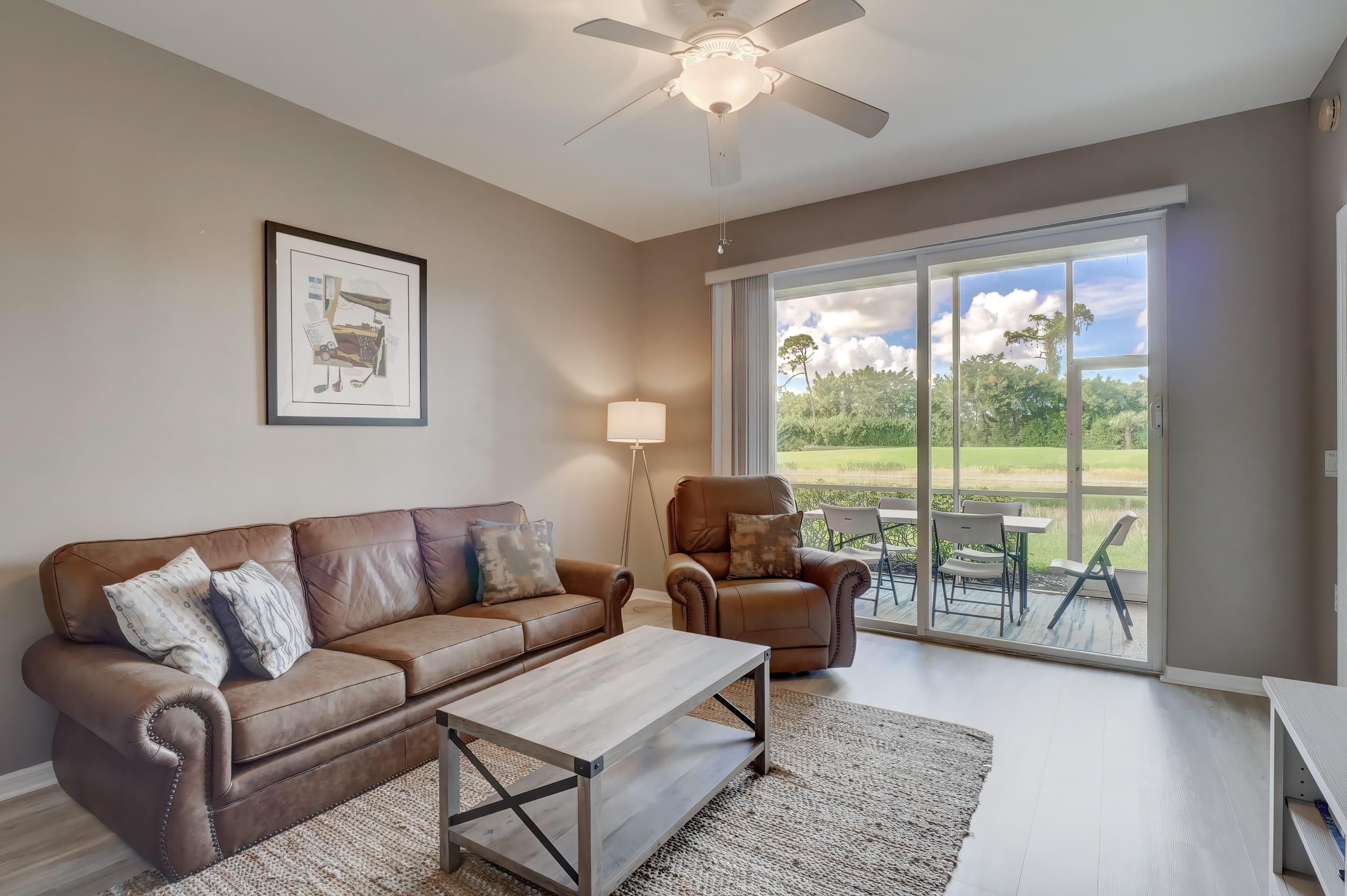 The Family Room is in the Back Left of the Condo and It has a Leather Sofa, Chair and a Large Coffee Table