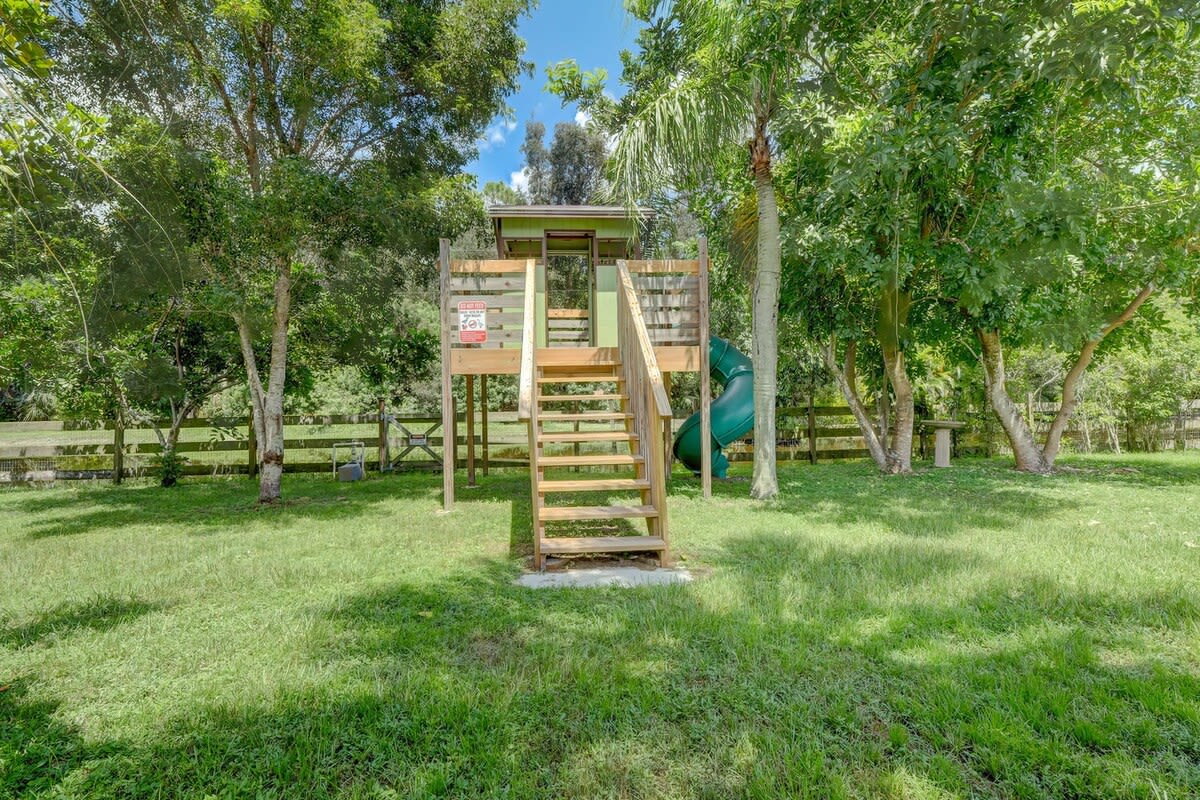 The Play Area Includes a Corkscrew Slide and It Has a Great View of the Pond Behind the Yard!