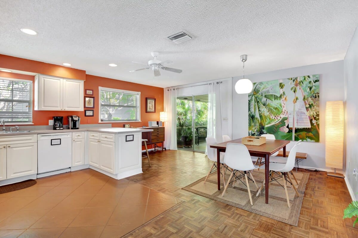 There Are So Many Cool Details Of The Home Throughout Including This Tropical Print Behind the Dining Table