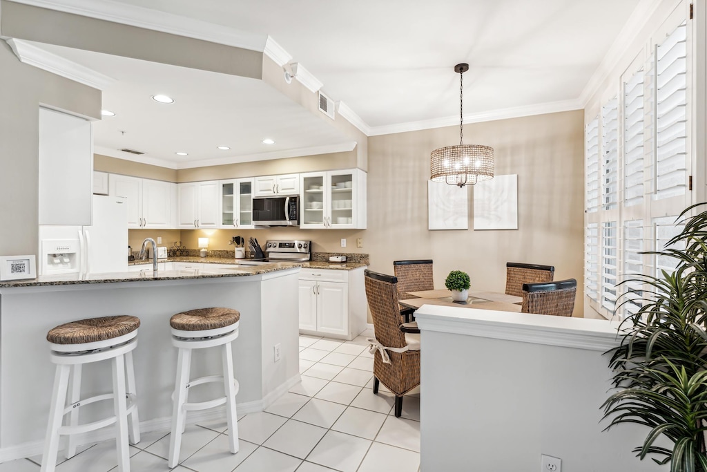 The kitchen has bar stools at the kitchen counter