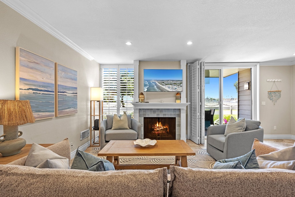 Unwind by the fireplace in a beautifully styled living room with modern furnishings and beachy touches