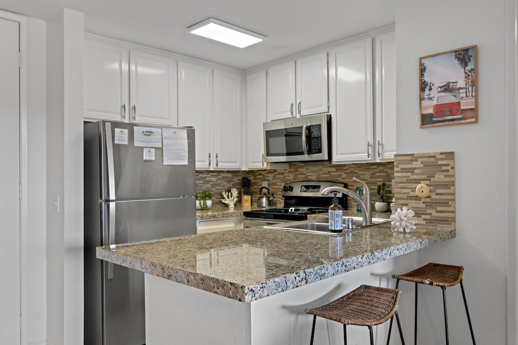 Two  bar stools offer extra seating by the kitchen island, ideal for younger children or enjoying a quick bite.