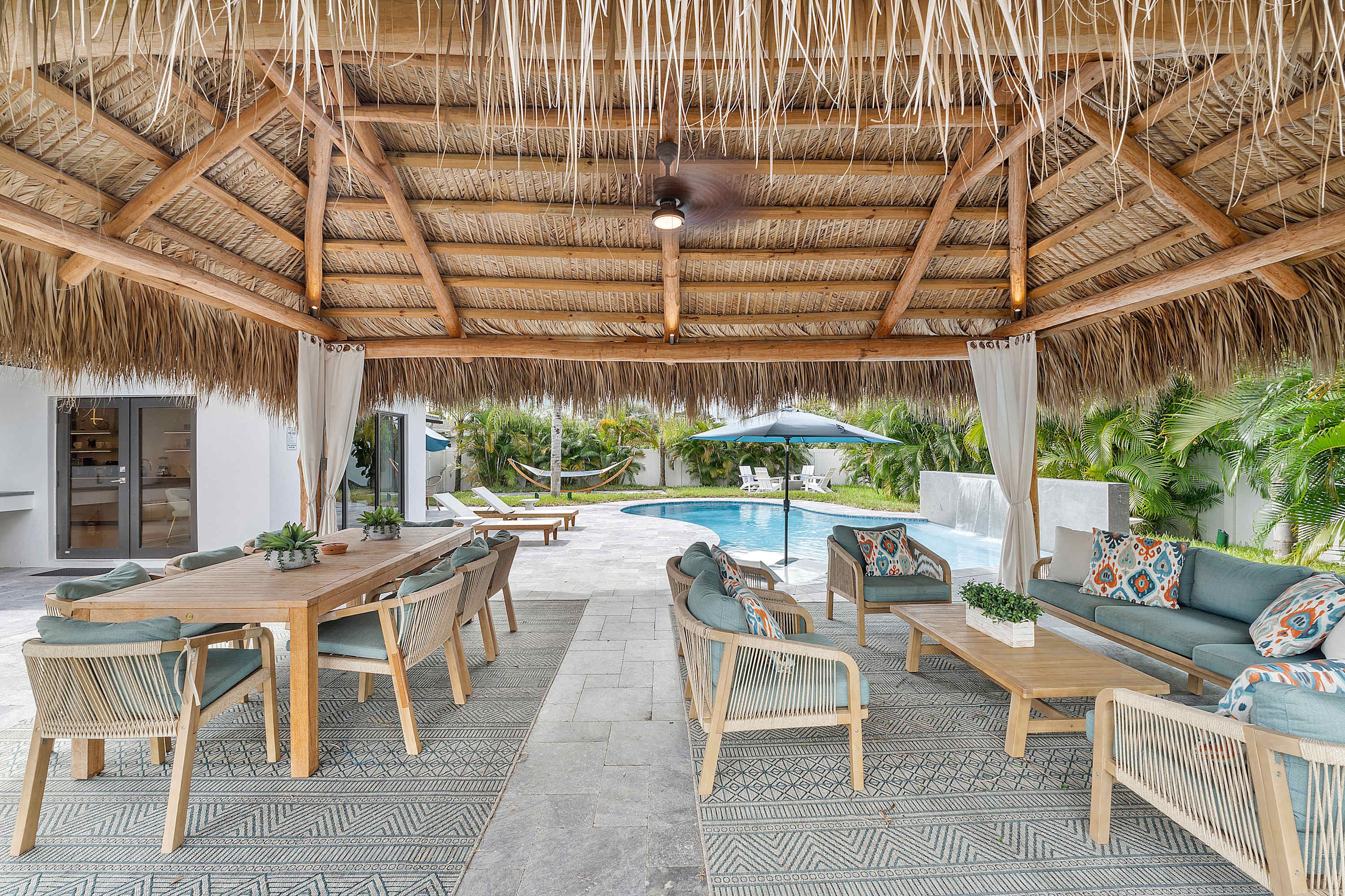 Enjoy the ultimate outdoor experience under our expansive Tiki Hut, with areas to dine and lounge