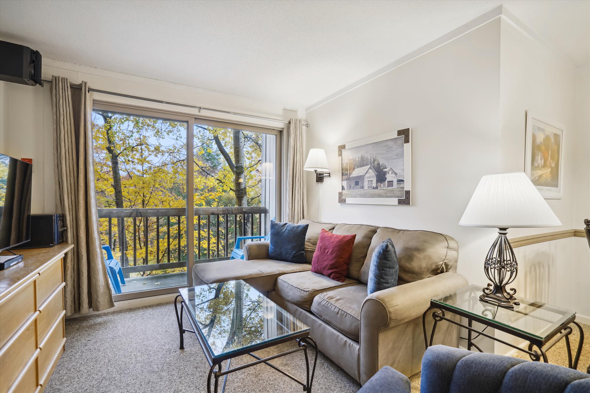 Living room with gas fireplace.  Lots of natural lighting with sliding glass doors, giving access to small decking.