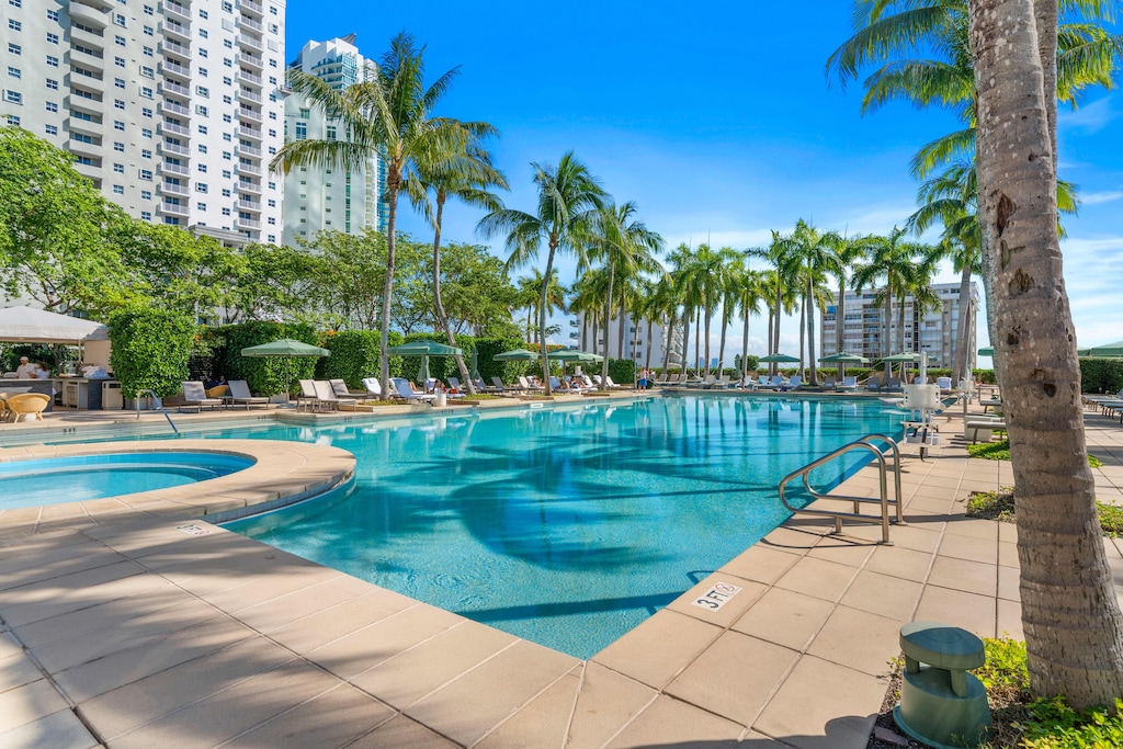 Resort Pool in Miami Florida - Relax by the shimmering poolside oasis - Dive into a refreshing poolside escape - Provides a relaxed atmosphere for unwinding
