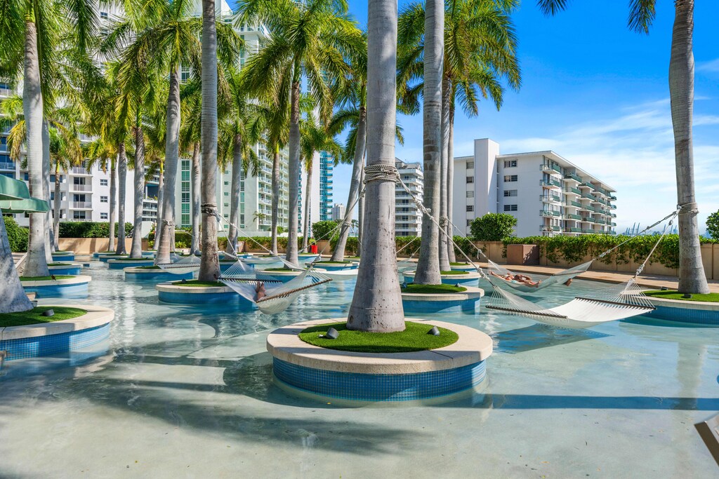 Blissful Escapes: Experience Ultimate Relaxation at the Four Seasons Hotel Miami, Whether Lounging Poolside or Swinging in the Hammocks of the Palm Grove.