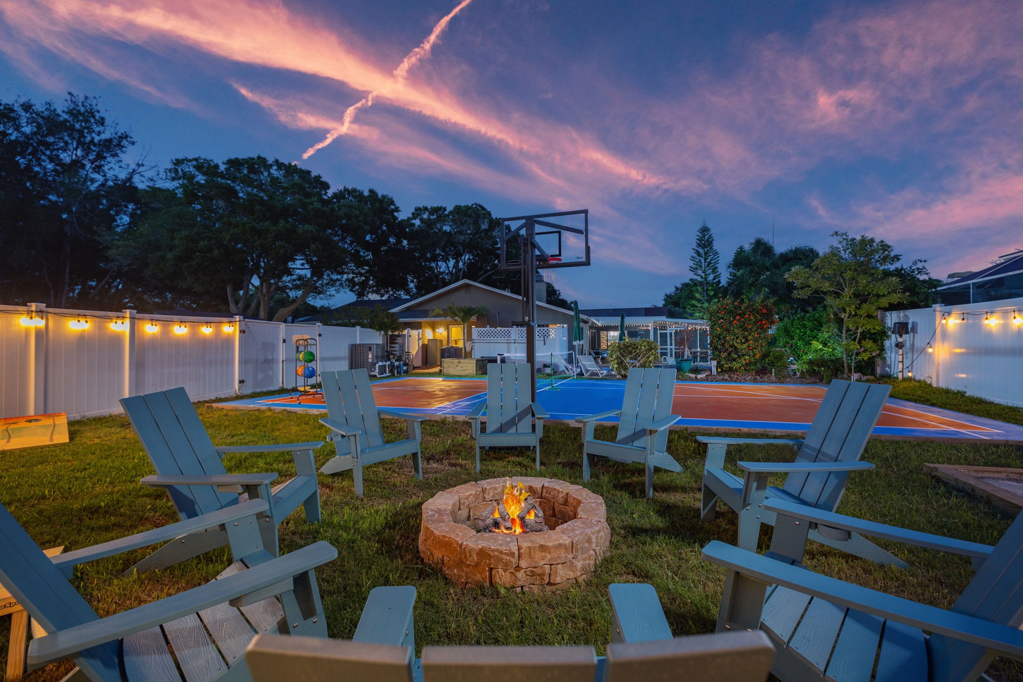 Cozy up by the outdoor firepit as the sun sets and casts a warm glow